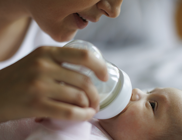 Smiling mother feeding
