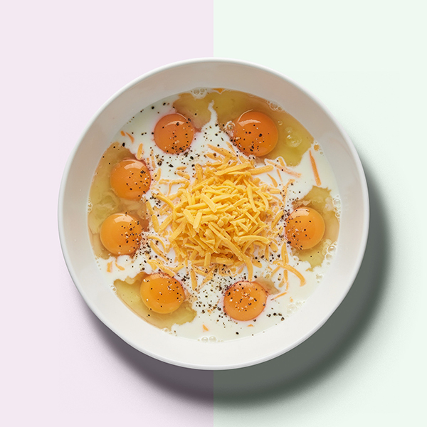 Eggs and cheese in mixing bowl