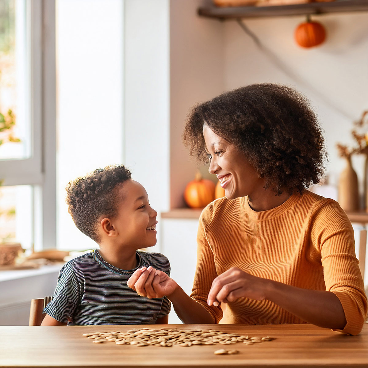 Mother and child sorting seeds at table together