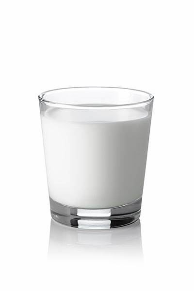Glass of milk on white background.