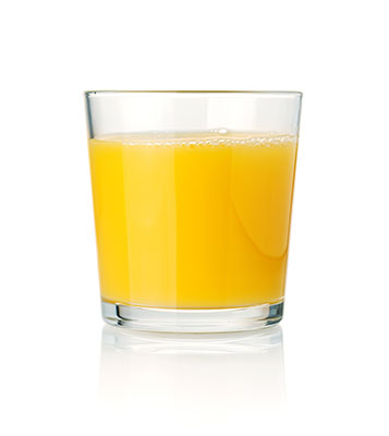 Glass of orange juice on white background.