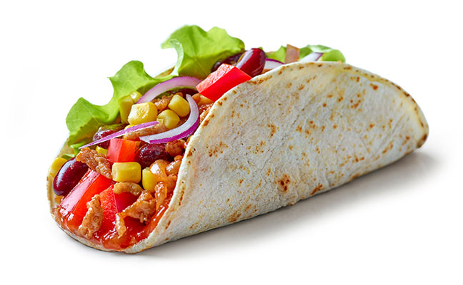 Soft taco filled with vegetables and meat.